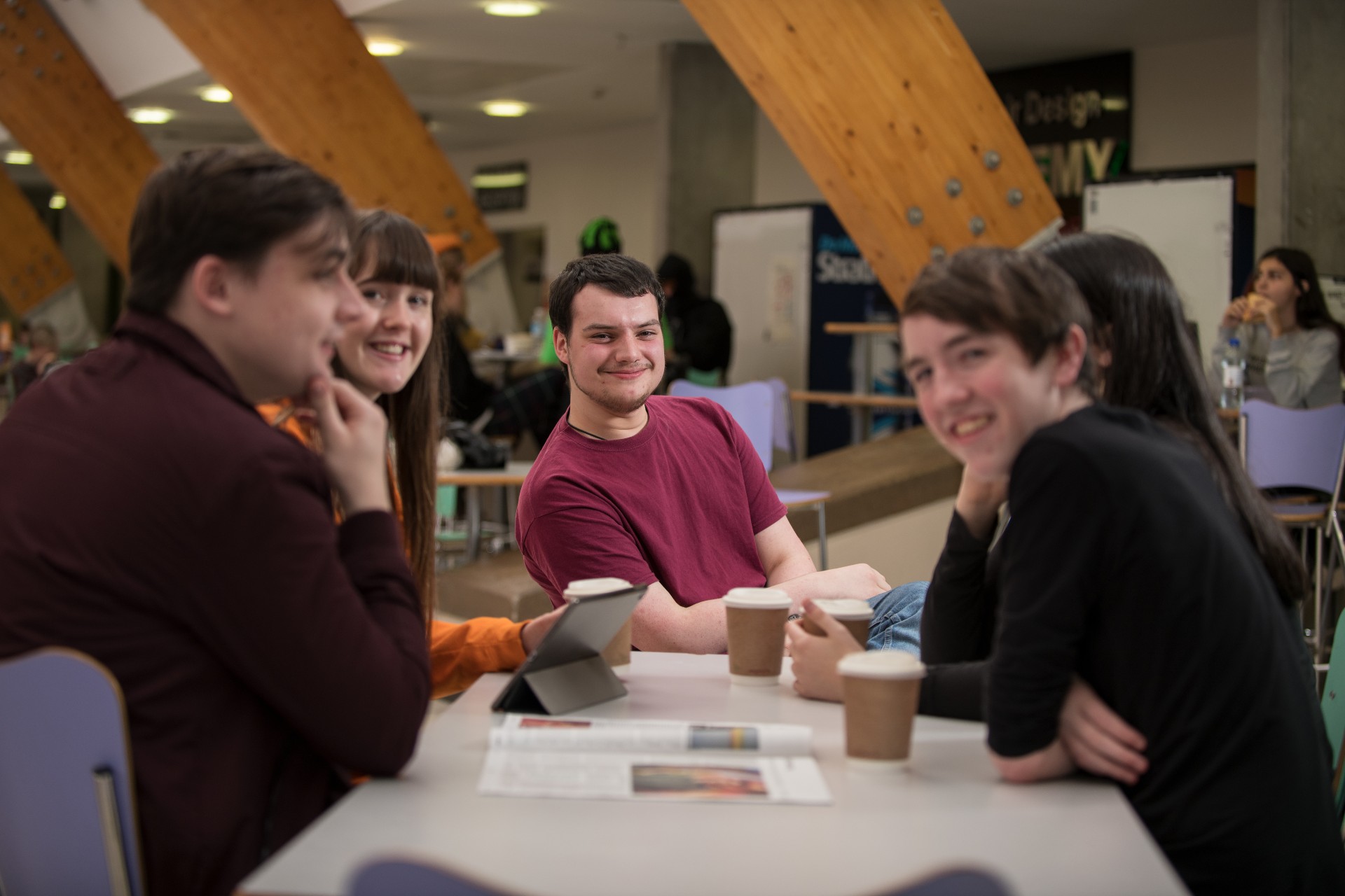 Group of students working together at a table on campus. 