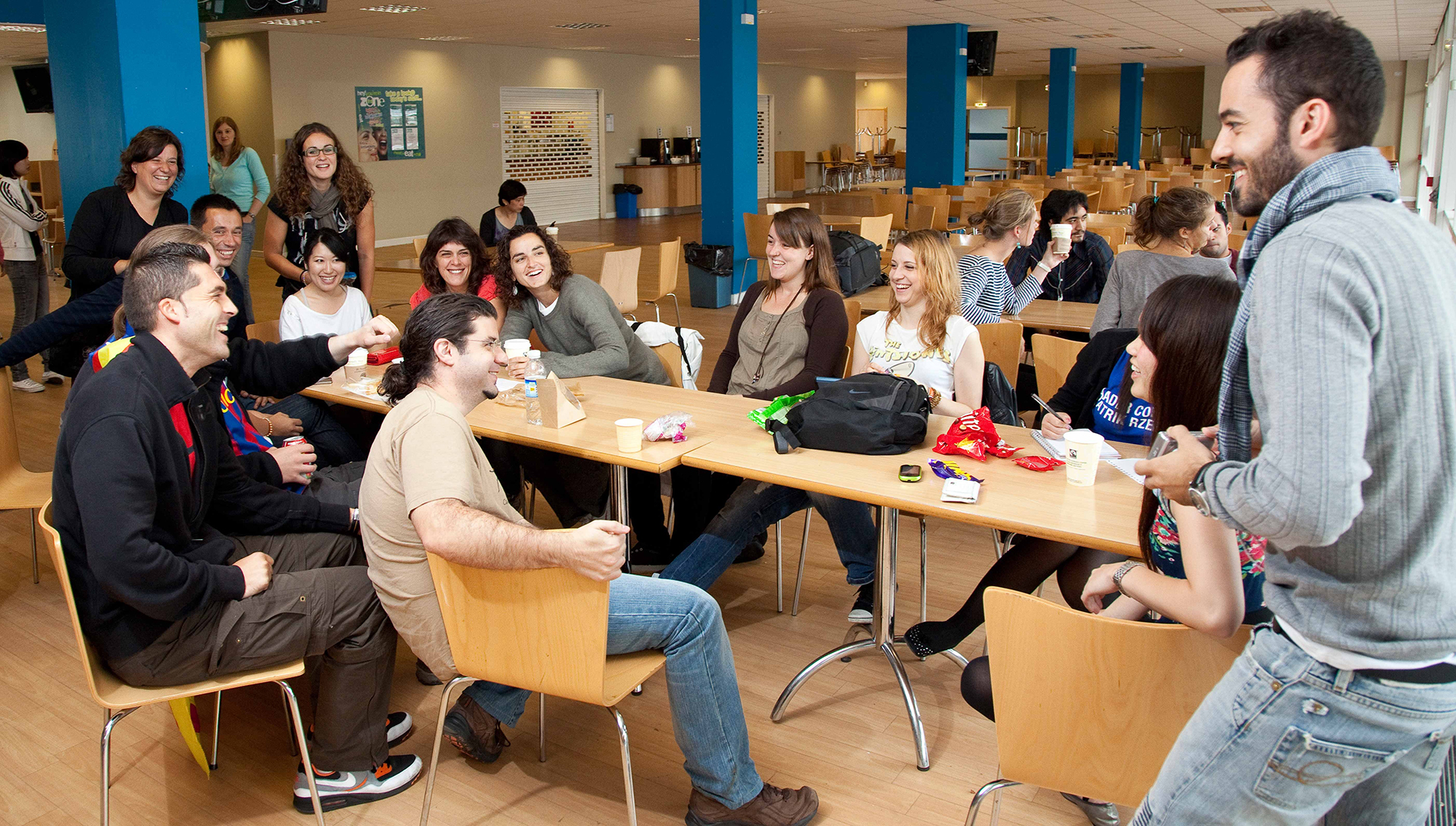 Group of students enjoying their lunch break in a canteen.